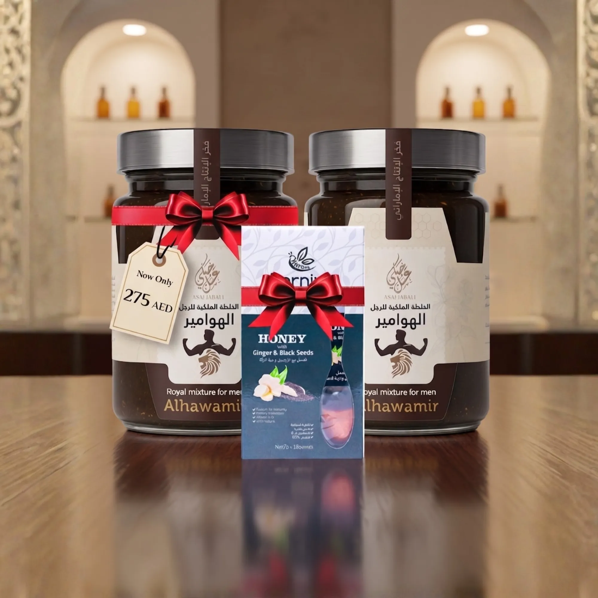 Two large honey jars in decorative gift boxes with red ribbons on a wooden surface. The background shows shelves and bottles.